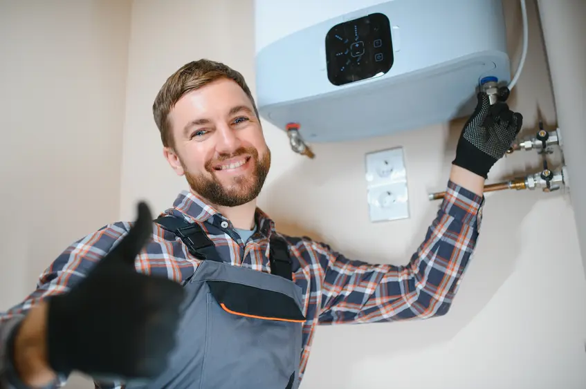 Professional plumber installing a tankless water heater